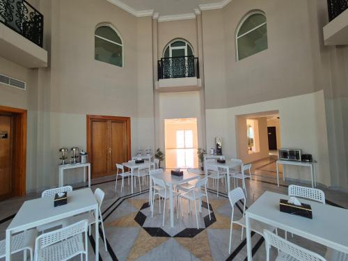 a room with tables and chairs in a building at Four Stars Residence in Dubai