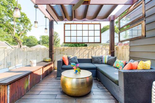 a patio with a couch and a table at Broad Ripple Getaway, Hot Tub, King Bed, Walk to Shops, Bike the Monon in Indianapolis