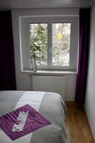 a bedroom with a bed and a window at Ferienwohnung Sonja am Weinberg in Radebeul