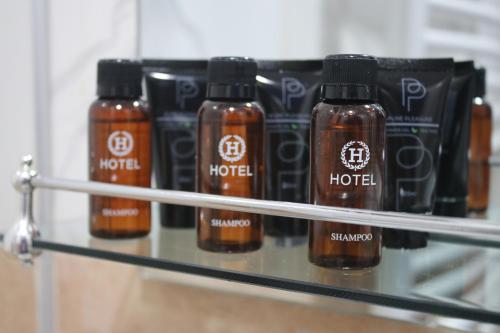 four bottles of hot sauce sitting on a shelf at Hotel Maria in Mestia