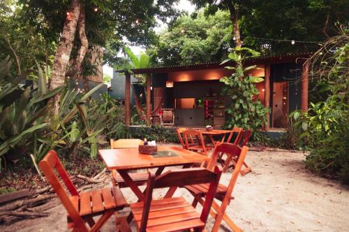 a wooden table and chairs in a yard at Taba Maraú in Marau