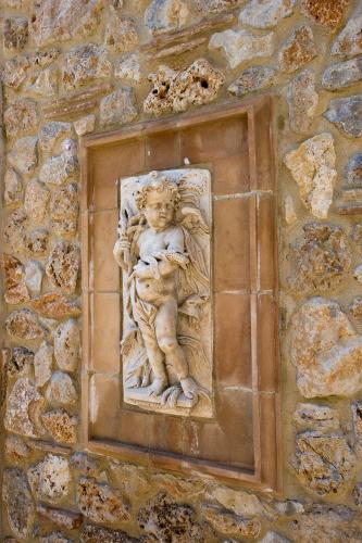 a statue of a child on a stone wall at Tenuta Del Gallo in Amelia