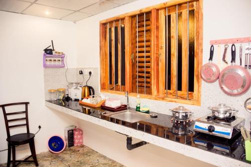 a kitchen with a sink and a counter top at Thatched Villa in Tangalle