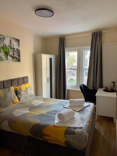 a bedroom with a bed with towels on it at Central quality point piccadilly in London