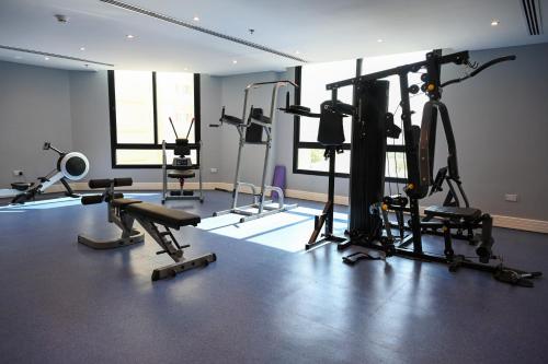 a gym with several exercise equipment in a room at Sherao Hotel Doha - Next to National Museum of Qatar & Metro - فندق شراعوة الدوحة - بجانب متحف قطر الوطني ومحطة المترو in Doha