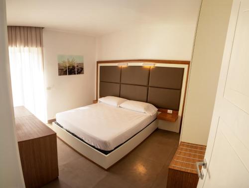 a bedroom with a large bed in a room at La Cicas Case Vacanze in Marina di Ascea