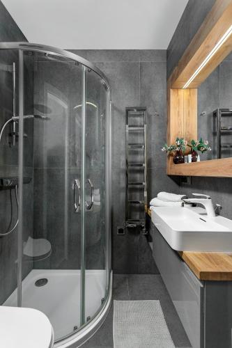 a bathroom with a shower and a sink at Soft Loft Legnicka in Wrocław