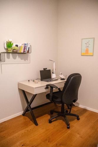 an office with a desk with a laptop and a chair at Beachfront in Ga‘ash