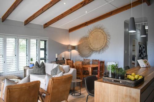 a living room with a couch and a dining room at MOS-Palmiet 72 in Kleinmond