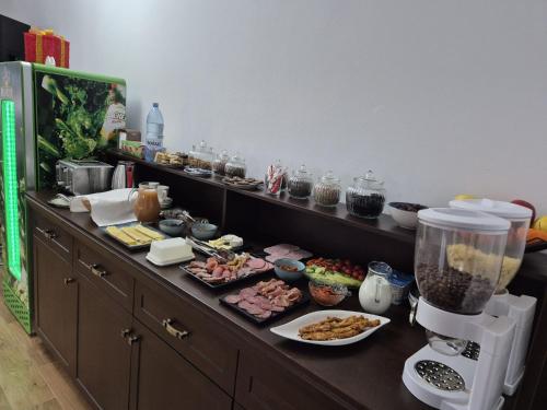a kitchen with a counter with food on it at Zestrea Maramureșului Săpânța in Săpînţa