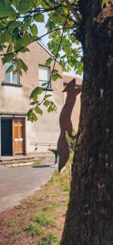 a shadow of a tree in front of a building at Chapelle Notre Dame du Rail in Jarny