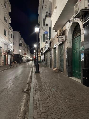 an empty street at night with a street light at Nul in Tetouan