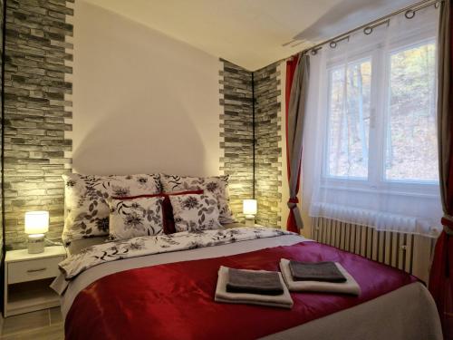 a bedroom with a bed with two towels on it at Penzion Stavař in Vrbno pod Pradědem