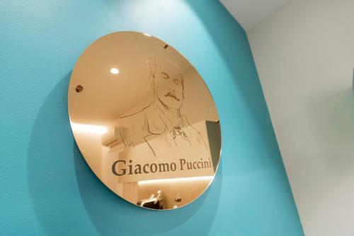 a round mirror with a picture of a man at Opera Relais De Charme - Aparthotel in Verona