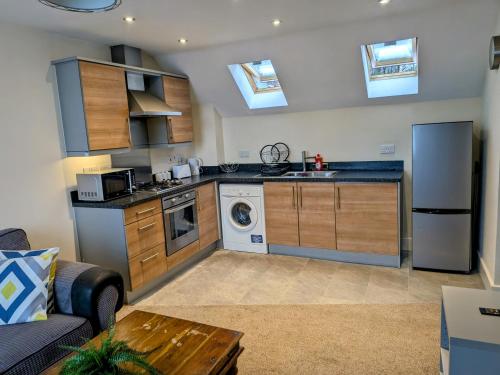 a kitchen with a couch and a table in a room at Stunning Modern 2 Bedroom Apartment - Perfect Getaway in Manchester