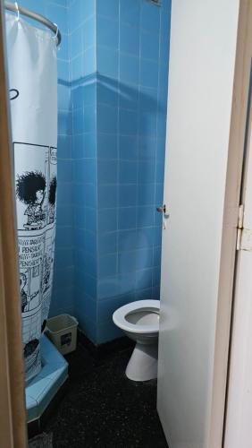 a blue bathroom with a toilet and a shower at Departamento Miramar frente al Mar - Edificio Stella Maris in Miramar