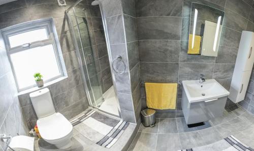 a bathroom with a shower and a toilet and a sink at The bungalow at Phoenix Court in Todmorden