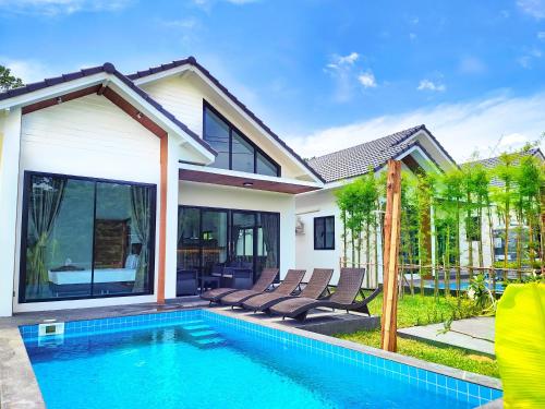 a villa with a swimming pool and a house at Sunny Petite Villa Close to Beach in Koh Samui