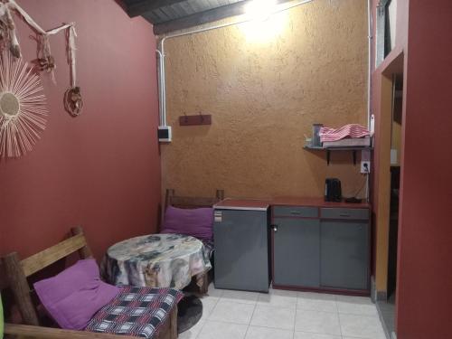 a room with two beds and a table at POSADA MI ESPERANZA in Cacheuta