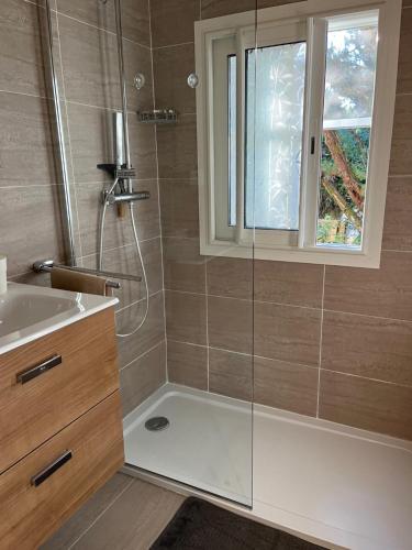 une salle de bain avec une douche et un lavabo et une fenêtre dans l'établissement Villa Nausicaa, à Pietrosella