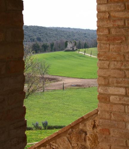 a view of a field from a brick wall at Tenuta Del Gallo in Amelia