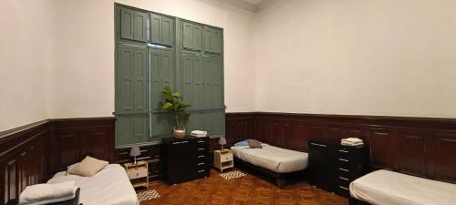a room with two beds and green cabinets at Casa Marina Huérfanos in Santiago