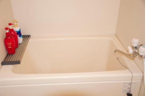 a white bath tub with a faucet next to at 全新装修南品川haven春 in Tokyo