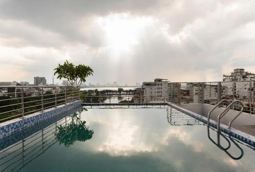a swimming pool on the roof of a building at Luxe Paradise Premium Hotel and Spa in Hanoi