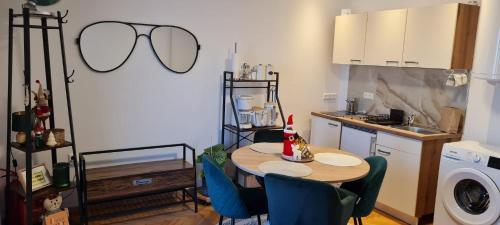 a kitchen with a table and chairs in a kitchen at aNNa s Cozy Home with Private Forest, Canopy Terrace & Parking, near Red Bull Ring in Sankt Michael in Obersteiermark