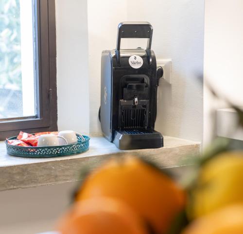 a food processor sitting on a counter next to a window at Maison Castro Casetta a Palermo in Palermo