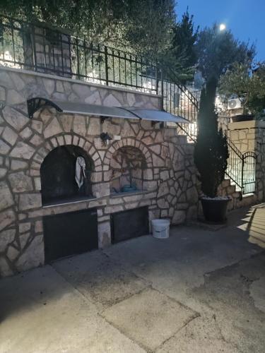an outdoor pizza oven in a stone wall at Biuk Apartments in Novi Vinodolski