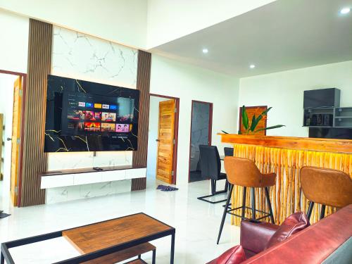 a living room with a bar and a tv at Sunny Petite Villa Close to Beach in Koh Samui