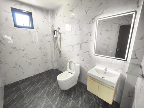 a bathroom with a toilet and a sink and a mirror at Sunny Petite Villa Close to Beach in Koh Samui