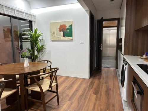 a kitchen and dining room with a table and chairs at The Hota House in Hanoi