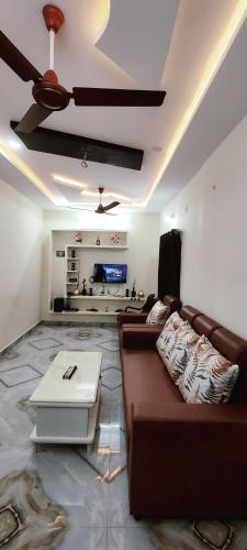 a living room with a couch and a table at Aneesha's Residence in Surūrnagar