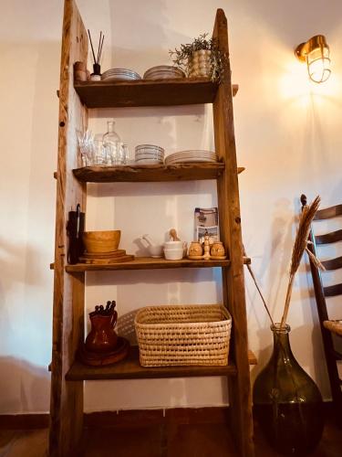 a wooden ladder shelf with dishes and a vase at Casa Nova, Moraira in Moraira