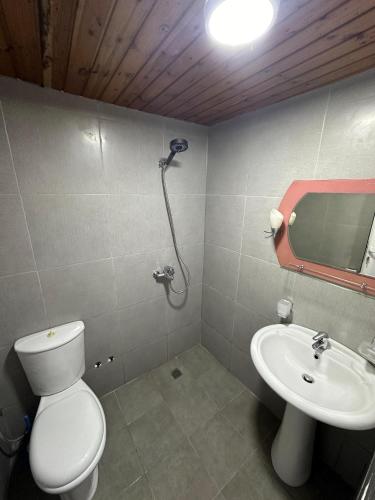 a bathroom with a toilet and a sink at Mayfair Apartment Ksamil in Ksamil