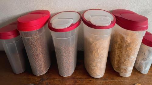 a group of four plastic containers filled with food at Hotel Cortez Azul in Alajuela City