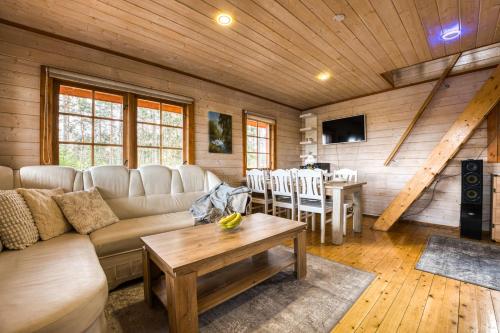 a living room with a couch and a table at Lake Escape - Cozy Lake House in Vagula Jaam