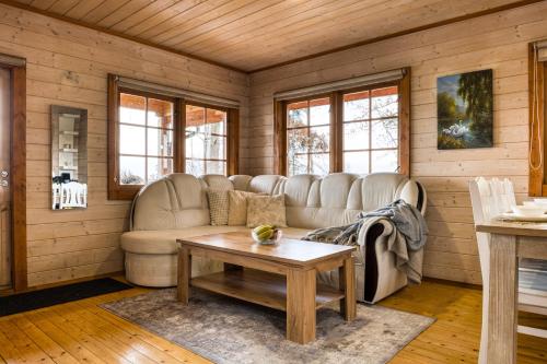 a living room with a couch and a table at Lake Escape - Cozy Lake House in Vagula Jaam