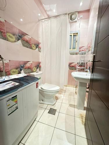 a bathroom with a toilet and a sink at In Apartments in Jeddah