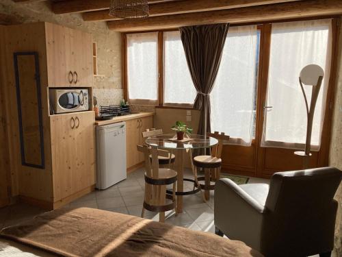 une cuisine avec une table et une salle à manger dans l'établissement Les 5 Crêts - Studio en Montagne, à Saint-Pierre-dʼAllevard