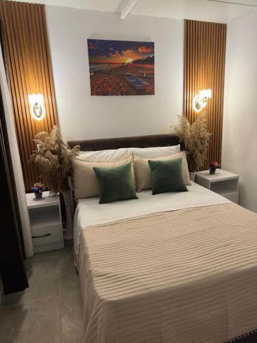 a bedroom with a large bed with two night stands at Mayfair Apartment Ksamil in Ksamil