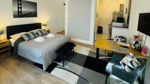 a bedroom with a bed and a table and a desk at Ferienwohnung Jurga in Pirna