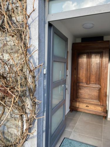 an entrance to a house with a wooden door at Il était une fois in Herbeumont