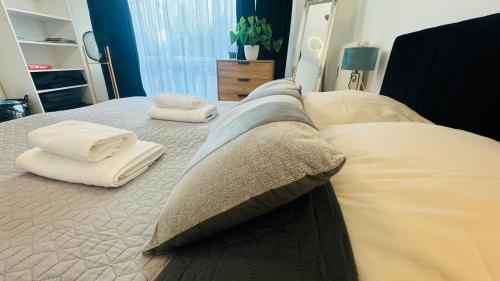 a bed with two pillows and towels on it at Ferienwohnung Jurga in Pirna