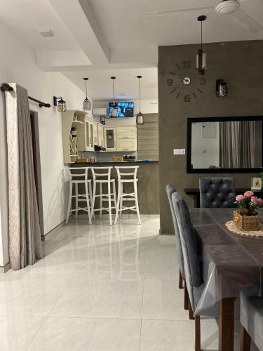 a kitchen and living room with a table and chairs at Villa Princess & Apartment in Hikkaduwa