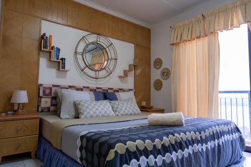 a bedroom with a large bed and a window at Jemhaus Studio Sunset Seaview [Netflix & Cuckoo] in Lumut