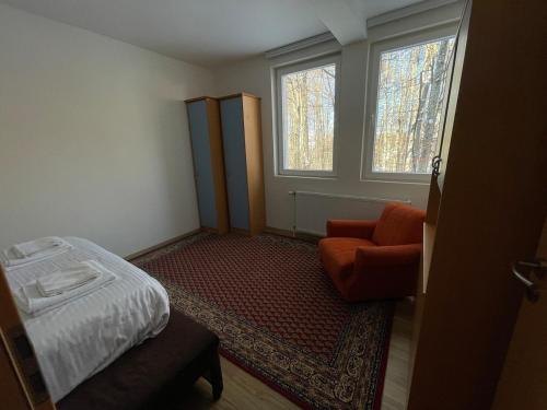 a small room with a bed and a chair at Black Fox in Ferizaj