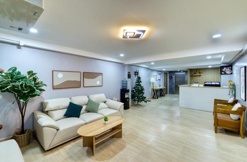 a living room with a couch and a table at AB House in Bangkok
